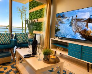 a living room with a tv and a table at Rosarito Papas & ocean view Condo in Rosarito