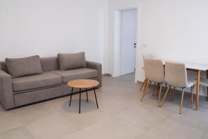 a living room with a couch and chairs and a table at Velipoja Residences in Velipojë