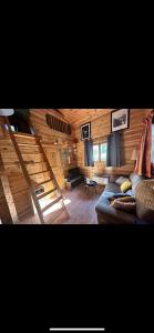 a living room with a couch and a staircase at Chalet 2 chambres à Estavar in Estavar