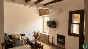 a living room with a couch and a fireplace at Casa Rural Crisol Spa in Arenas de San Pedro