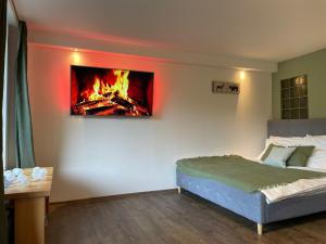 a bedroom with a bed and a fire in the wall at Cedron Apartments in Benecko