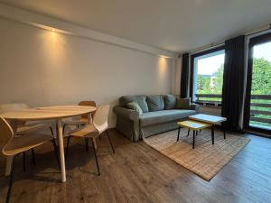 a living room with a couch and a table at Cedron Apartments in Benecko