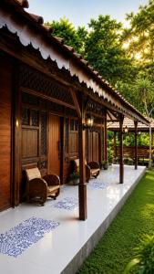 a pavilion with chairs and tables in a garden at Mahatva Borobudur Resort in Borobudur
