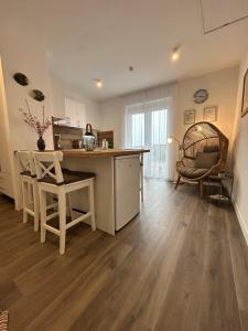 a kitchen with a counter and a table and chairs at Villa Field6 in Révfülöp