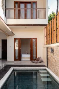 a house with a swimming pool and a bedroom at oemah samiya in Keramas