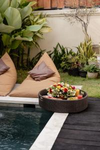 a tray of food sitting on a table next to a pool at oemah samiya in Keramas
