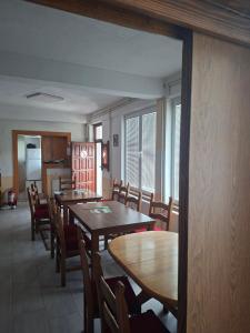 a dining room with wooden tables and chairs at VRATA IGMANa in Hadžići