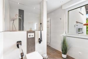 a bathroom with a sink and a bird on the wall at Ferienwohnung Kleine Auszeit in Eslohe +28 photos
