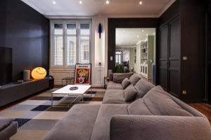 a living room with a couch and a table at Le Duval 66 in Pontarlier