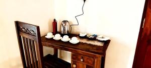 a wooden table with cups and a blender on it at Freedom Life Yala in Tissamaharama +1 photo