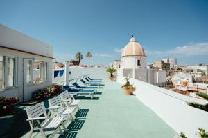 a row of chairs on the roof of a building at Pensione Di Lustro in Forio d'Ischia