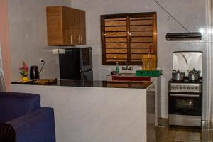 a kitchen with a counter top and a stove at Mailos Accommodation in Songo +5 photos
