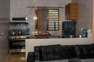 a kitchen with a stove and a counter top at Mailos Accommodation in Songo