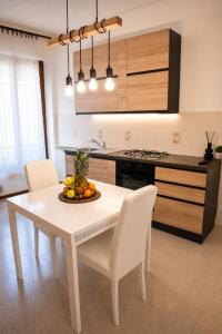 a kitchen with a table with a bowl of fruit on it at Luna al Monte in Cuasso Al Monte +6 photos