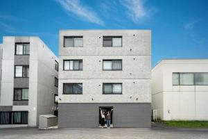two people standing in the doorway of a building at Lotus south in Sapporo