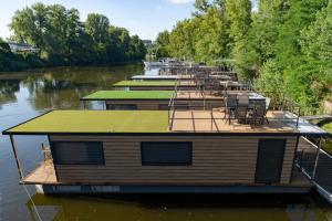 a group of boats parked on a river at Prague River Houseboats - Private Bay in Prague