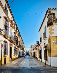 an empty street in a city with buildings at Hostal Baobab in El Puerto de Santa María