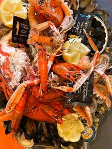 a pile of lobster and other seafood on a plate at Maison Albatros in Pyla-sur-Mer +13 photos