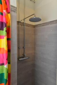 a shower in a bathroom with a colorful shower curtain at Hostel Finnmyrten in Juoksengi