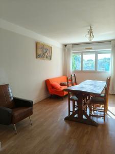 a dining room with a table and chairs and a couch at Chambre d'hôte Mont mouton in Laferté-sur-Amance