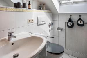 a bathroom with a sink and a toilet at Weitblick in Breitnau +28 photos