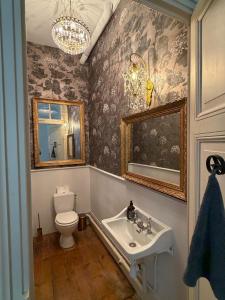a bathroom with a toilet and a sink at Queen's Escape in Martel