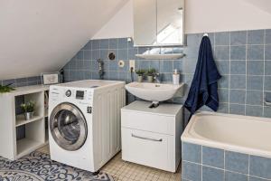 a bathroom with a washing machine and a sink at Ferienappartement Sonnenhof in Triberg