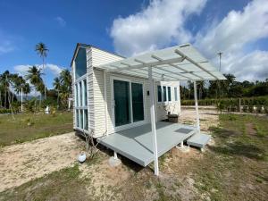 a tiny house on the beach with a porch at Beach Access Tiny House 06 - Lipa Noi Beach in Koh Samui