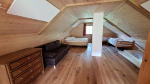 a room with a couch and a bed in a attic at Luis Haus in Molln