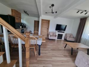 a living room with a table and chairs and a couch at Liziera Cabin Malaia in Malaia