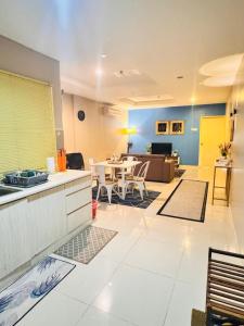 a kitchen and living room with a table and chairs at Silver Place Marina Island Lumut in Lumut