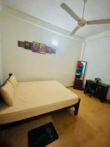 a room with a bed and a ceiling fan at Aluvihare Residence in Matale +9 photos