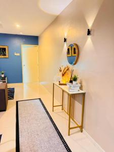a living room with a table and a blue wall at Silver Place Marina Island Lumut in Lumut +12 photos
