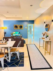 a living room with a table and a couch at Silver Place Marina Island Lumut in Lumut