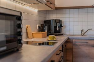 a kitchen with a counter with a plate of food on it at Apartment BergStyle in Pfronten +8 photos