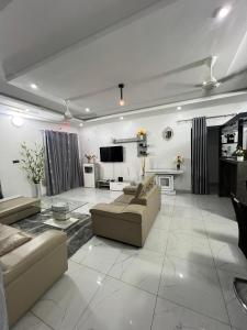 a large living room with couches and a tv at TGS home in Lomé