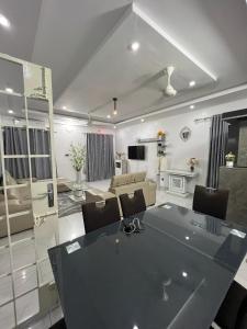 a large living room with a table and chairs at TGS home in Lomé