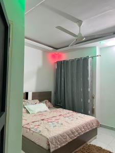 a bedroom with a bed with a ceiling fan at TGS home in Lomé