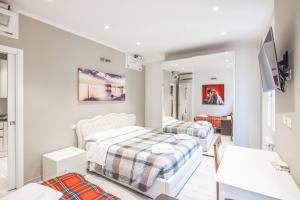 a white bedroom with two beds in a room at De'Giudei, Bologna by Short Holidays in Bologna