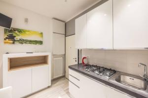 a kitchen with white cabinets and a sink at De'Giudei, Bologna by Short Holidays in Bologna +15 photos