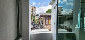 an open window with a view of a city at Old City Hall, Contactless Check In in Bangkok