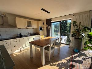 a kitchen with a wooden table and a dining room at Apartment Osso 3 in Arnhem +5 photos