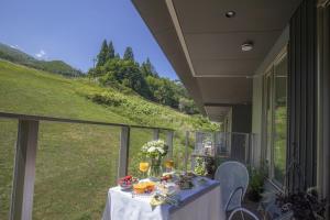 a table on the balcony of a house at STARRY Residence Suite Hakuba Happo-one in Hakuba