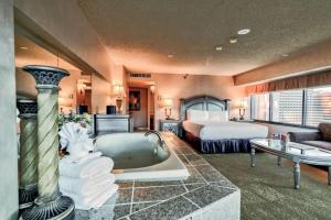 a hotel room with a tub and a bed at Eldorado Reno Hotel & Casino - A Caesars Rewards Destination in Reno +63 photos