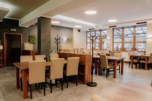 a dining room with wooden tables and chairs at Penzion Maděřič in Moravský Žižkov