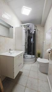 a bathroom with a sink and a shower and a toilet at Domaine Les Tourelles - La petite maison in Caffiers +41 photos