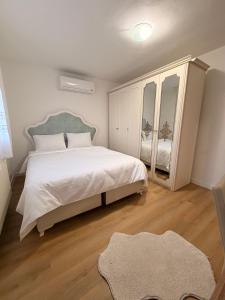 a bedroom with a large bed and a mirror at Vila Noor Sarajevo in Sarajevo +24 photos