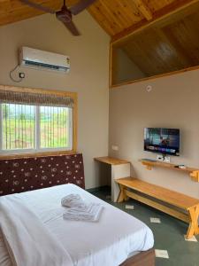 a bedroom with a bed and a flat screen tv at Dream Habitat in Wādhiware