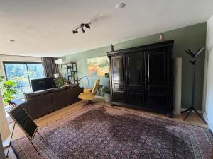 a living room with a couch and a tv at Apartment Osso 3 in Arnhem