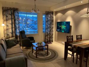 a living room with a couch and a dining room at Levistar II 1414 in Kittilä
